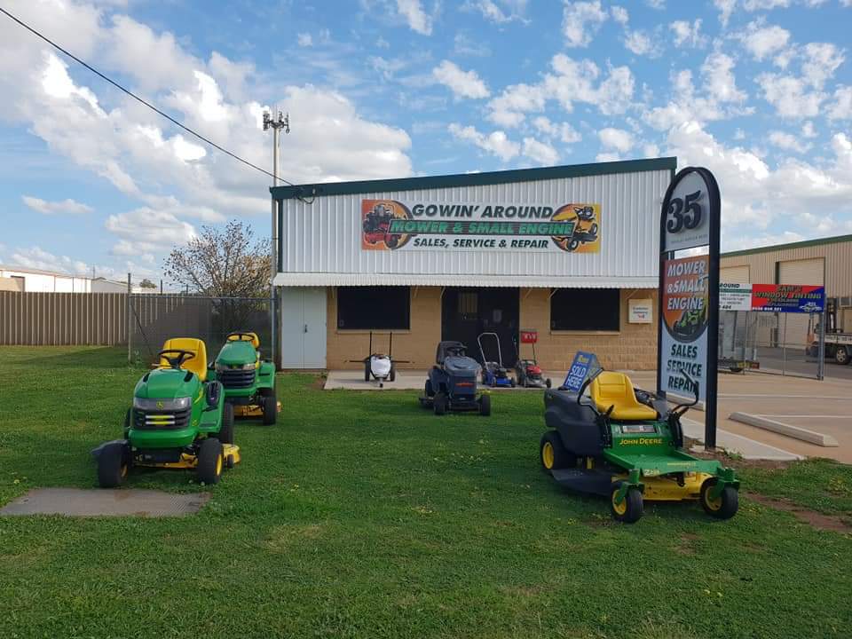 John Deere ride-on mowers and a John Deere zero-turn lined up on the lawn outside Gowin’ Around